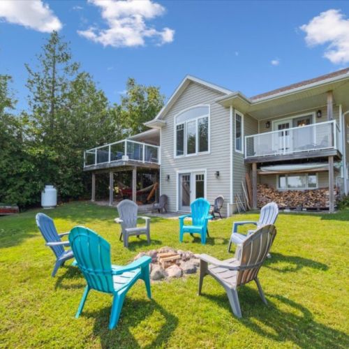 Gather around the firepit for cozy evenings under the stars, with stunning views of the lake and the warm glow of your private retreat behind you.