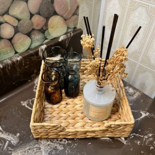 Elegant and rustic home decor featuring a scented diffuser and decorative glasses, adding a touch of coziness and class to the cottage.