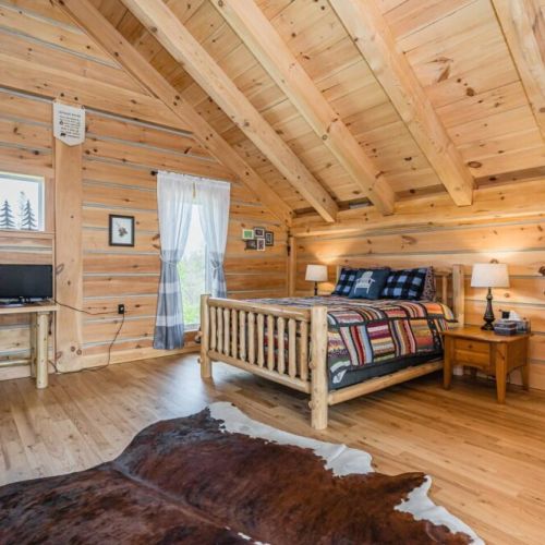 Ascend to the loft to find one of the two semi-private bedrooms, offering a blend of cozy retreat and family-friendly space. The serene setting is perfect for relaxation and rejuvenation.