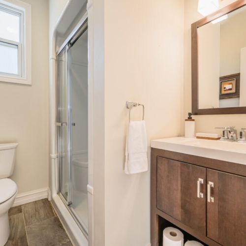 Modern and functional, this clean bathroom features a walk-in shower and fresh towels—everything you need for a comfy stay.