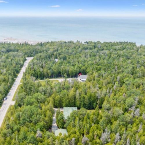 Set on a quiet residential road with Lake Huron nearby, this property blends convenience with tranquility.