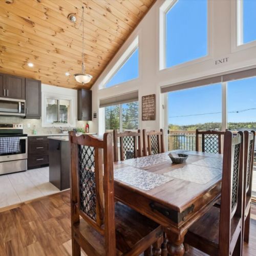 Enjoy meals with a view in the sun-filled dining area overlooking the surrounding landscape and water.
