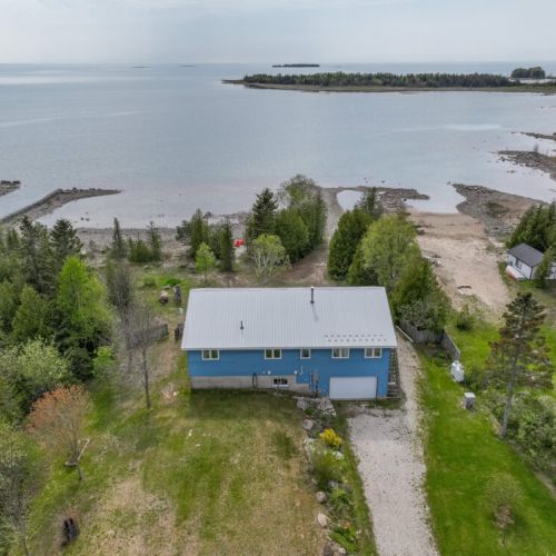 Bird’s-eye view of the cottage nestled along Lake Huron’s edge. A perfect home base for exploring the Bruce Peninsula and enjoying waterfront serenity.