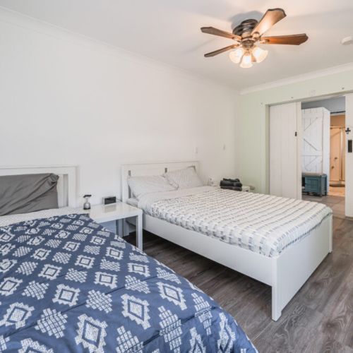The third guest bedroom features two double beds for use.