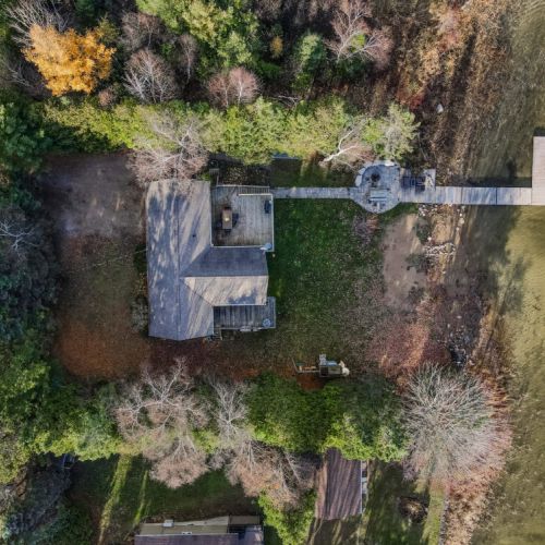Take a bird's-eye view of the expansive backyard, revealing a harmonious symphony of space, serenity, and recreational delights.