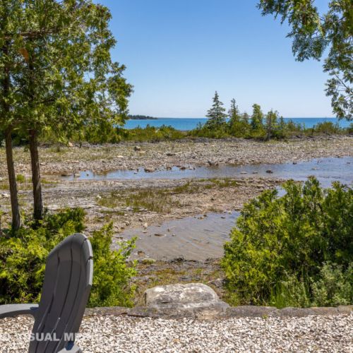 Lake view from the fire-pit area—enjoy morning coffee or evening sunsets surrounded by nature.