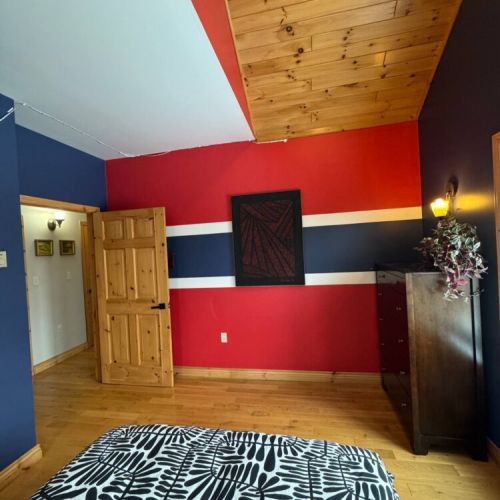Bold and bright, this stylish bedroom features a unique colour scheme, wood ceilings, and cozy lighting—perfect for design-savvy travelers.