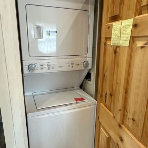 In-suite stacked washer and dryer available for guest use at Sunset Villa.
