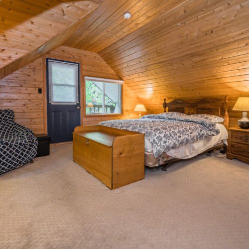 The Master bedroom features soft & fluffy linens with a classic cottage vibe all around you.