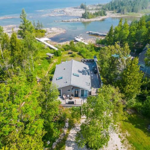 Aerial view of the cottage and surrounding shoreline — your private getaway in the heart of Bruce Peninsula beauty.