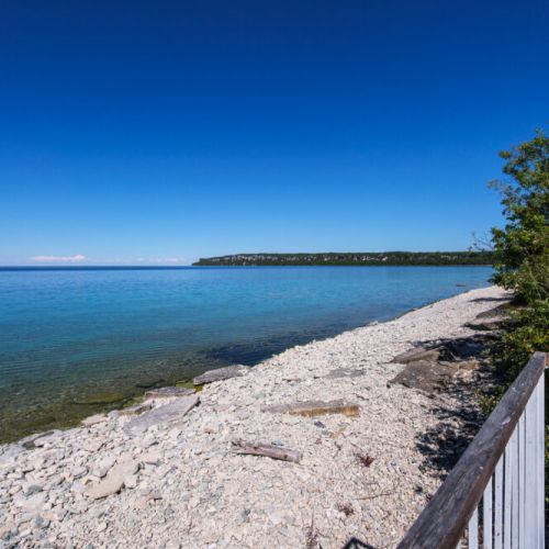 The pristine limestone shoreline invites you to explore the crystal-clear waters at your own pace.